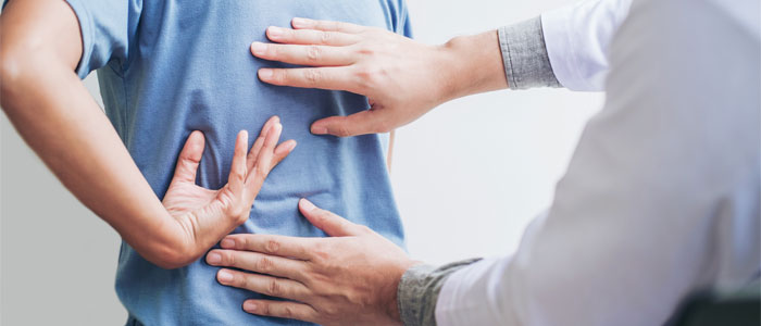 chiropractor evaluating man with scoliosis